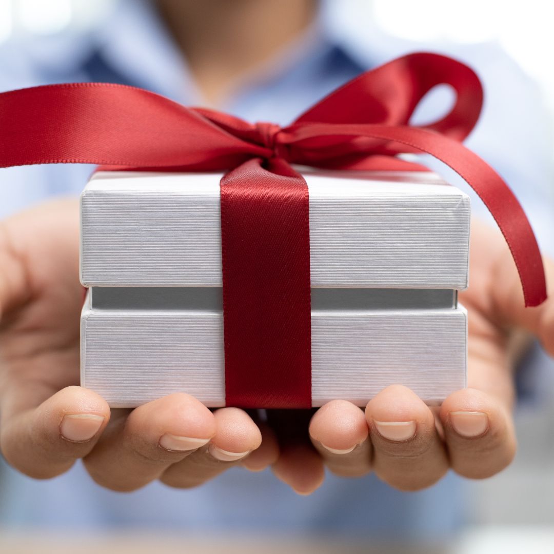 Gift presented to someone. Red Ribbon